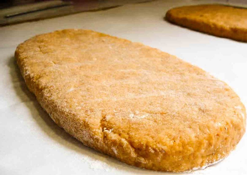 dough shaped into logs on parchment paper