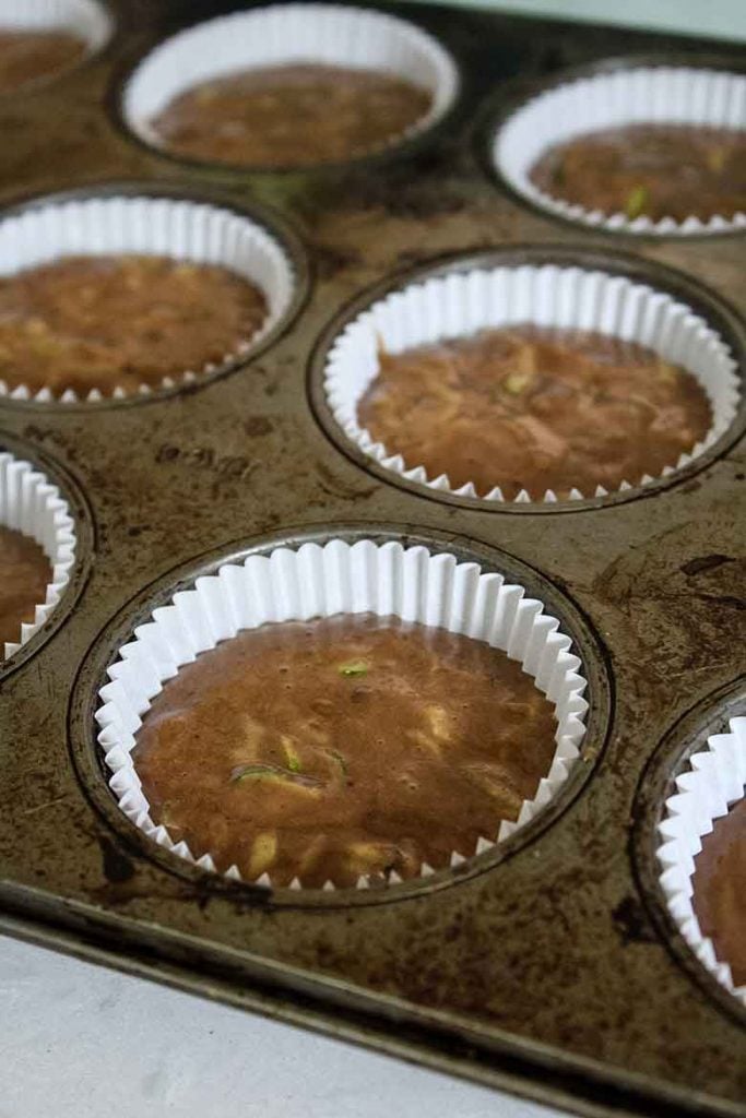 chocolate banana zucchini muffin batter in paper lined muffin tin