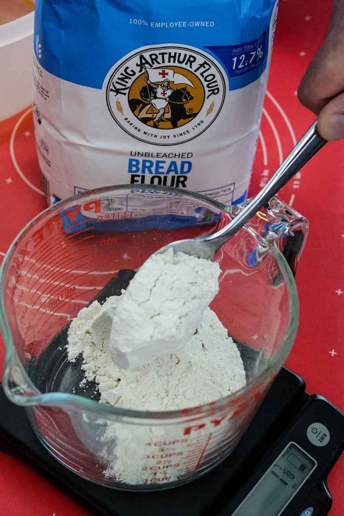 flour being weighed on scale to portion