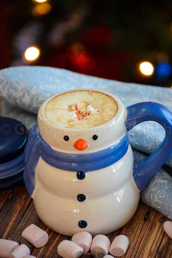 creamy hot cocoa in a snowman mug with crushed sugar-free peppermint on top