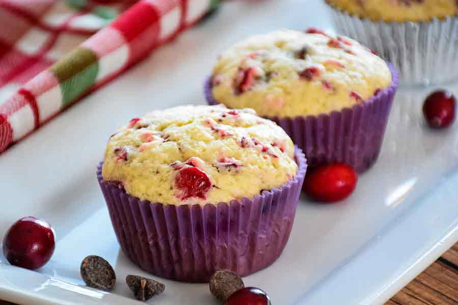 Baked Orange Cranberry muffins on a white tray.