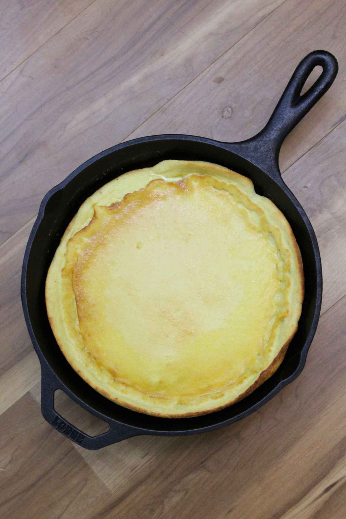 Overhead image of Chocolate Macadamia Keto Dutch Baby baked in a cast iron skillet.