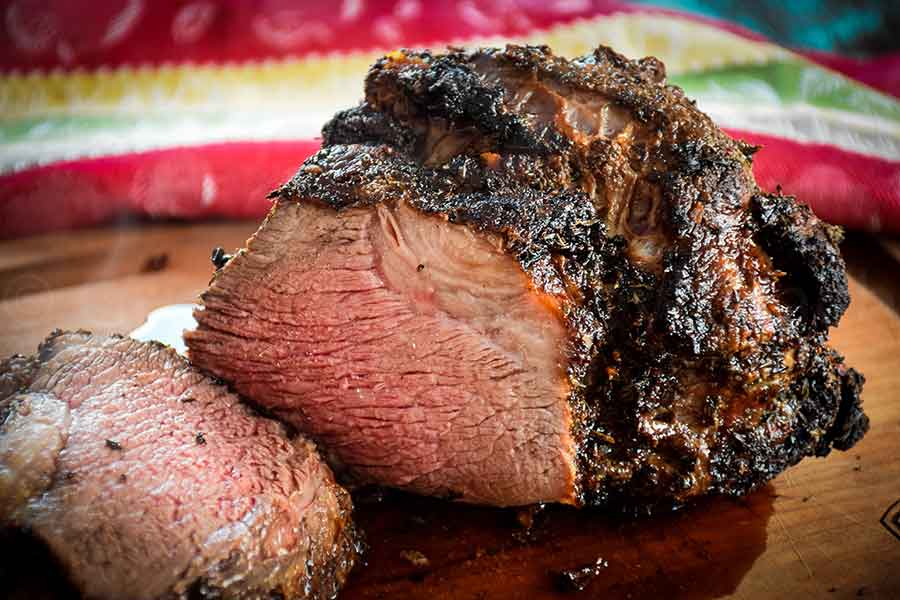 Air Fryer Roast Beef on cutting board with slices cut from the roast