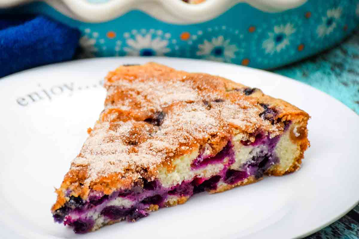 A slice of Blueberry Coffee Cake with Cream Cheese on a white plate - featured image