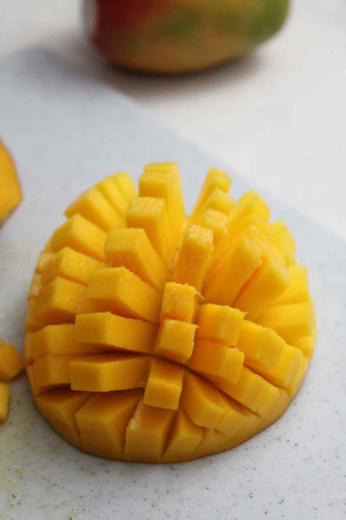 Fresh mango that has been scored.