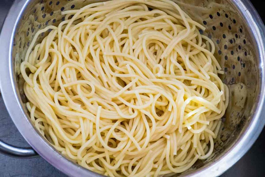 a colander with cooked pasta 