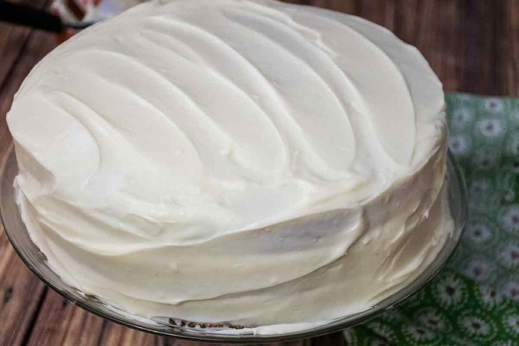 a cake frosted with cream cheese frosting