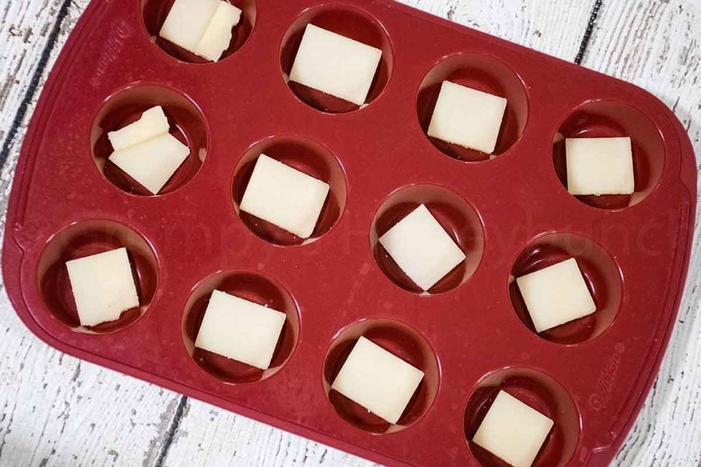 slices of cheese in the silicone mini muffin pan