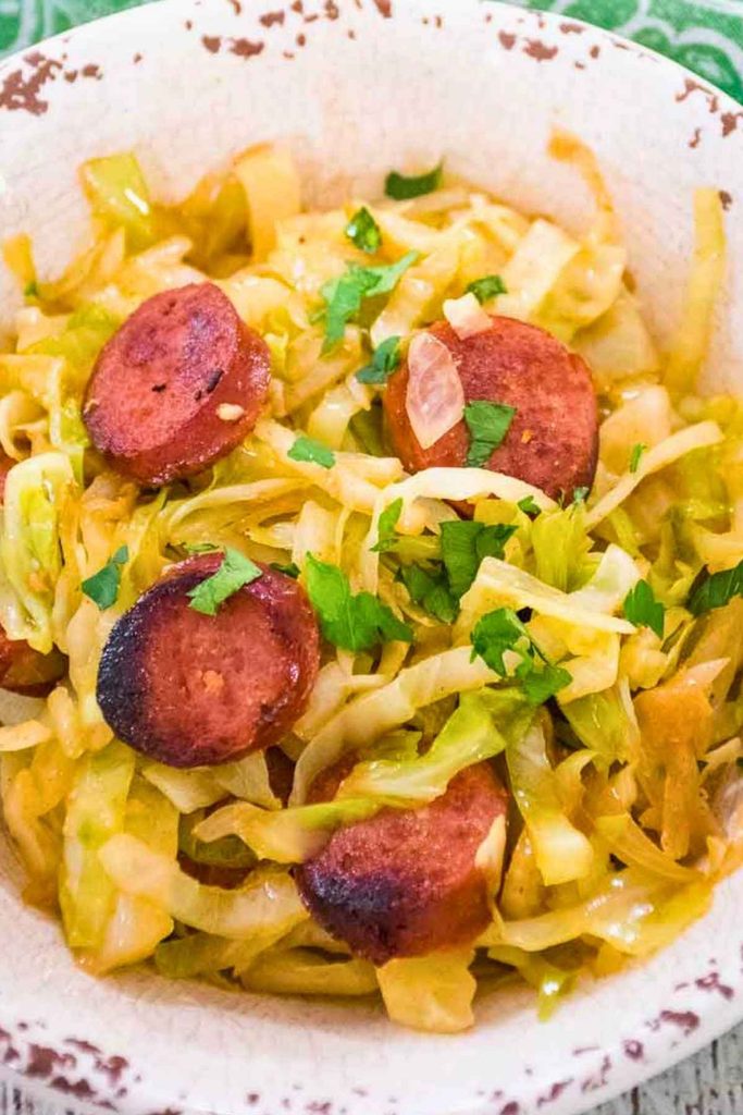 Overhead view of a serving bowl of food garnished with parsley.
