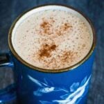 A frothy cup of keto snickerdoodle coffee in a blue mug.