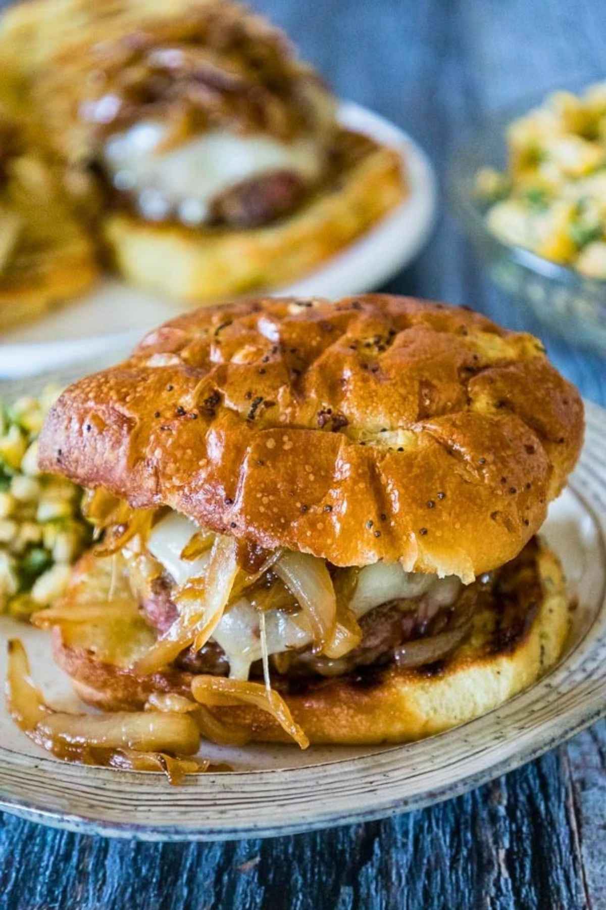 French Onion Burger on an onion bun topped with Swiss cheese and caramelized onions.
