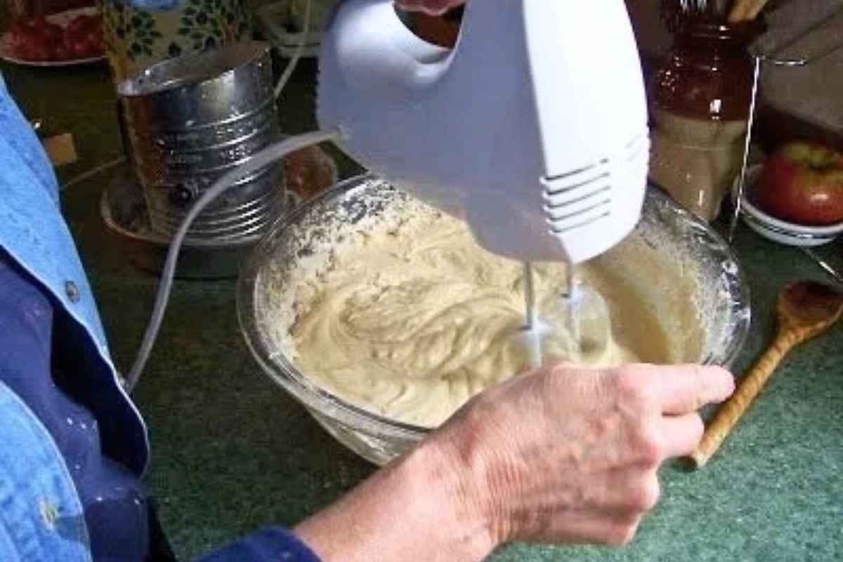 Mixing wet and dry ingredients with hand mixer.