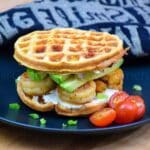 Featured image of a Shrimp and Avocado Chaffle on a black plate.