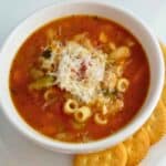 A white bowl of minestrone soup.