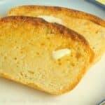 Featured image of two slices of toasted English Muffin Bread spread with melty butter.