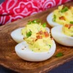 Shrimp Deviled Eggs with bacon and green onion garnish.