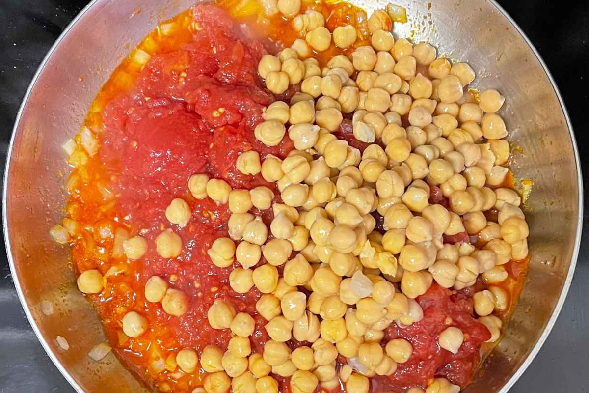 Chickpeas and tomatoes in skillet.