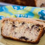 A slice of keto banana bread studded with chocolate chips and sugar free peanut butter frosting.