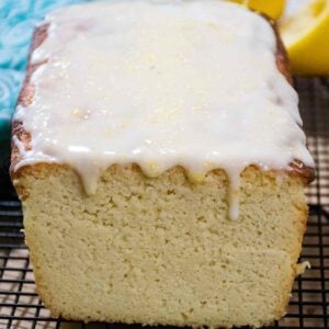 Upclose image of keto lemon pound cake on a cooling rack topped with drizzly icing.
