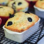 Buttermilk Blueberry Muffin in a ceramic loaf pan on a cooling rack.