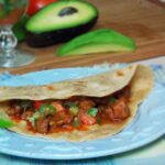 Chicken carnitas on a homemade flour tortilla.