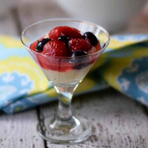 Macerated berries in a mini martini glass.