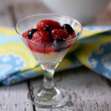 Macerated berries in a mini martini glass.