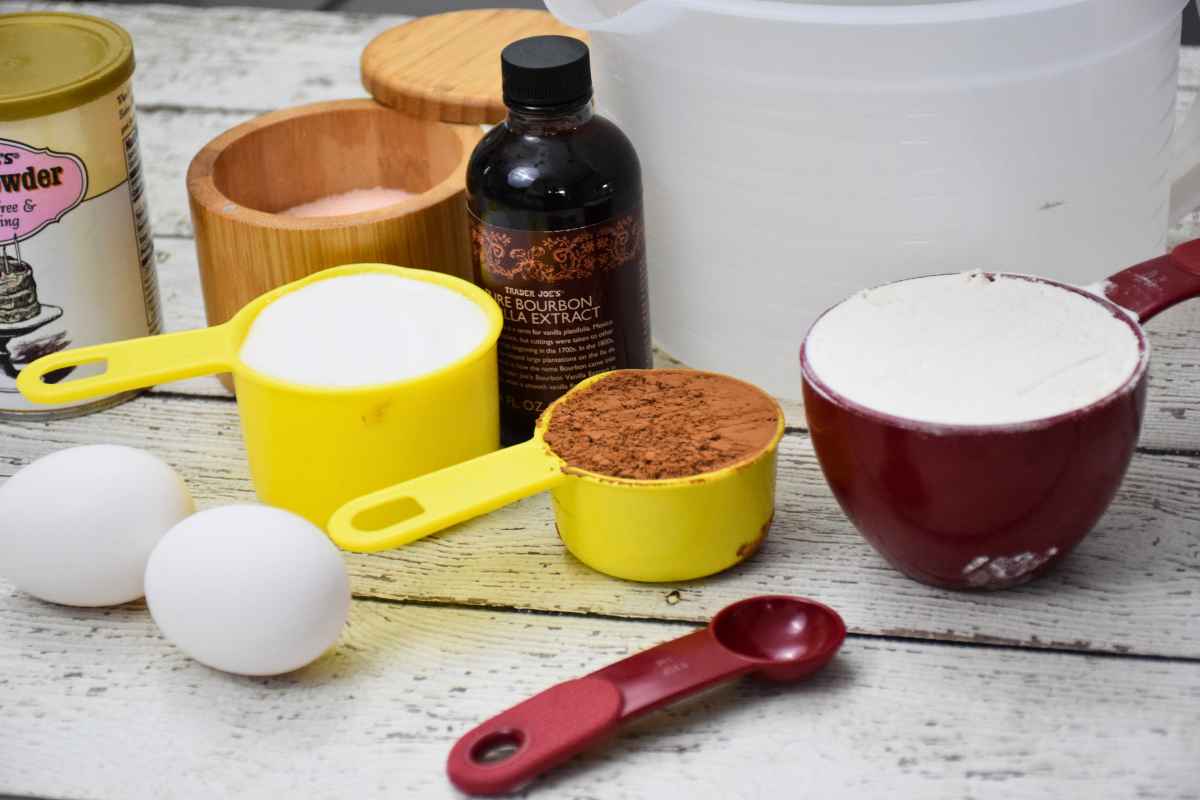 Ingredients for cookies: flour, cocoa powder, sugar, eggs, vanilla extract, baking powder, and salt.