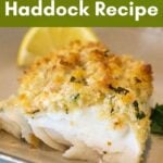 A serving of baked haddock topped with a golden, crispy breadcrumb coating, garnished with a lemon wedge and parsley, with the text "Easy Baked Haddock Recipe" at the top and the website grumpyshoneybunch.com at the bottom.