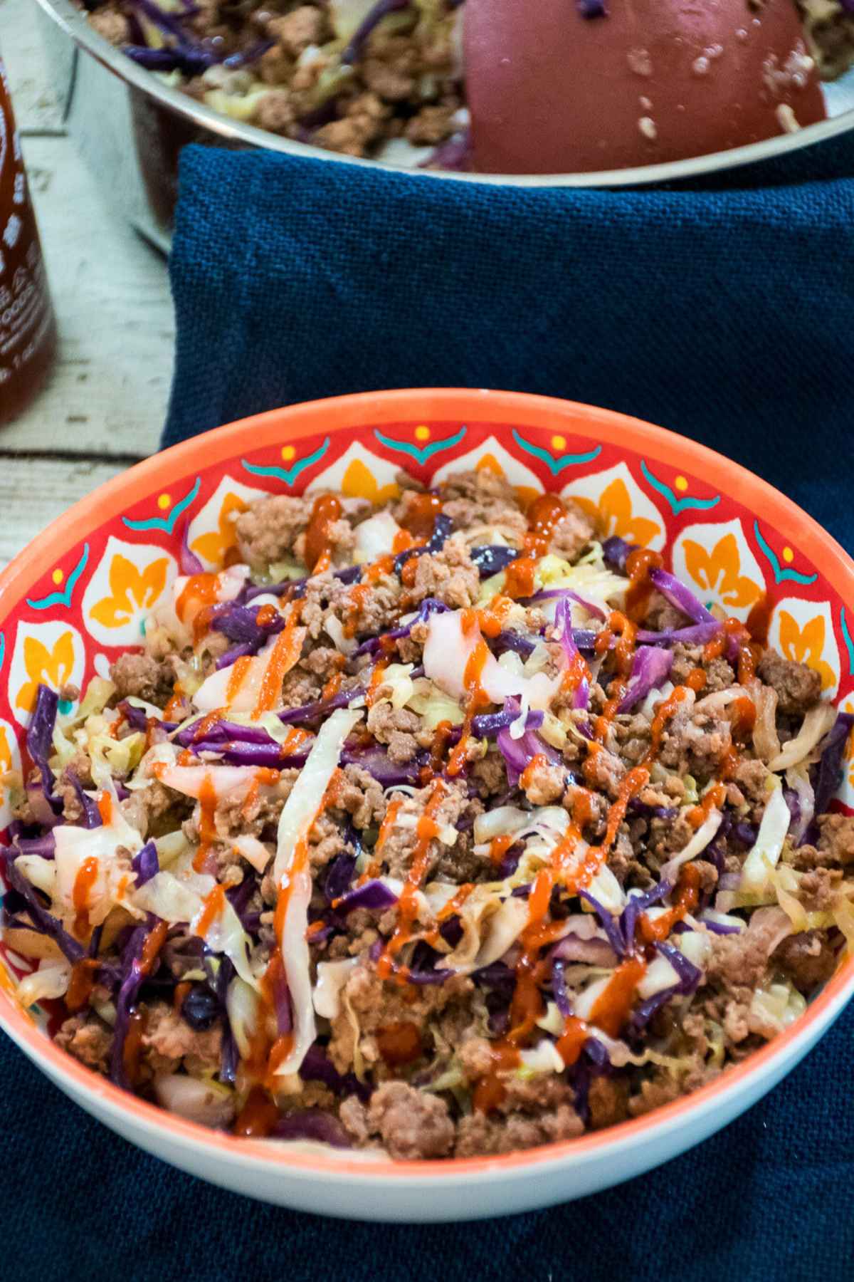Healthy Venison Eggroll in a bowl with shredded cabbage and sriacha drizzle - a 20 minute keto dinner.