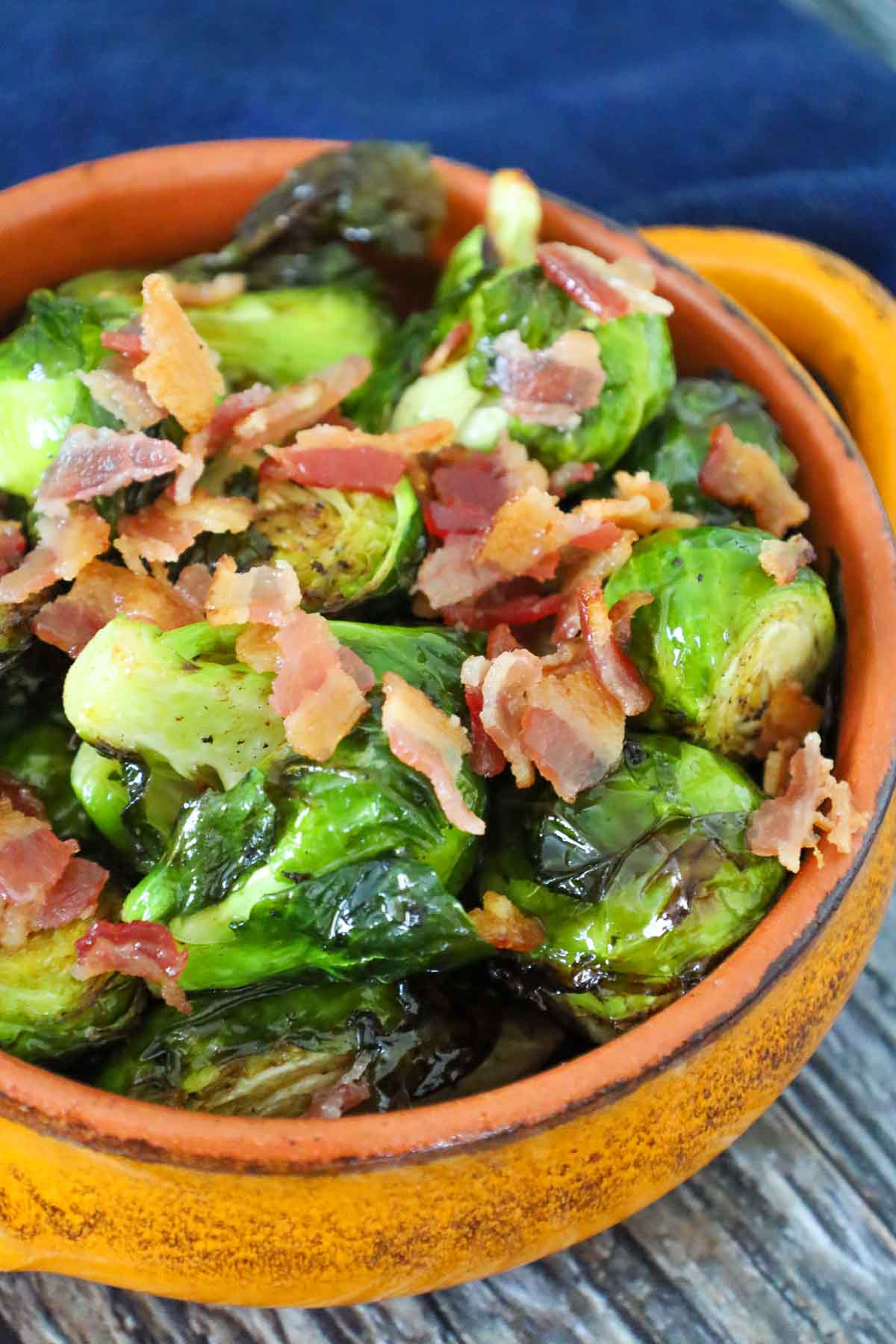Crispy air fryer brussels sprouts topped with bacon pieces and tossed in a browned balsamic butter.