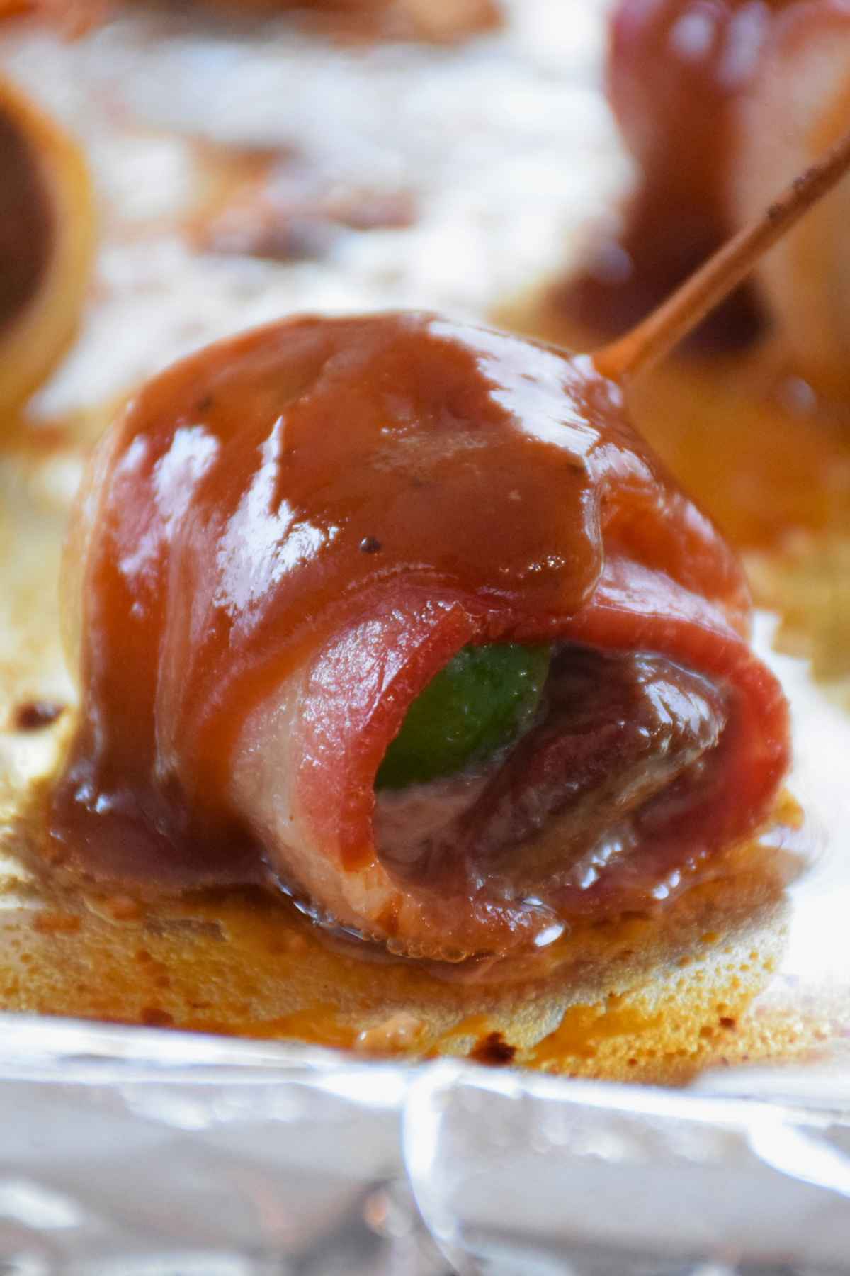 Partially baked venison appetizer bite coated with barbecue sauce.