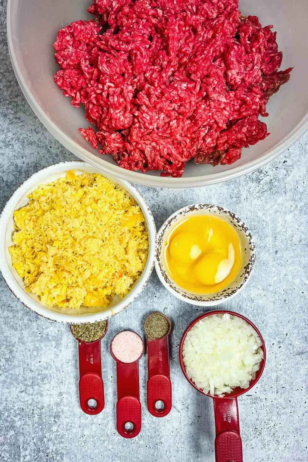 Ingredients for meatballs including ground beef, bread crumbs, eggs, onions, and seasonings.