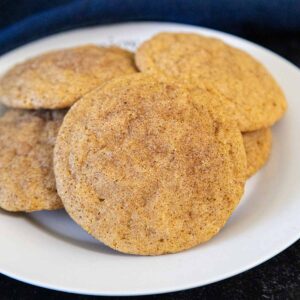 Plate of soft and chewy pumpkin snickerdoodle cookies with a cinnamon sugar coating.