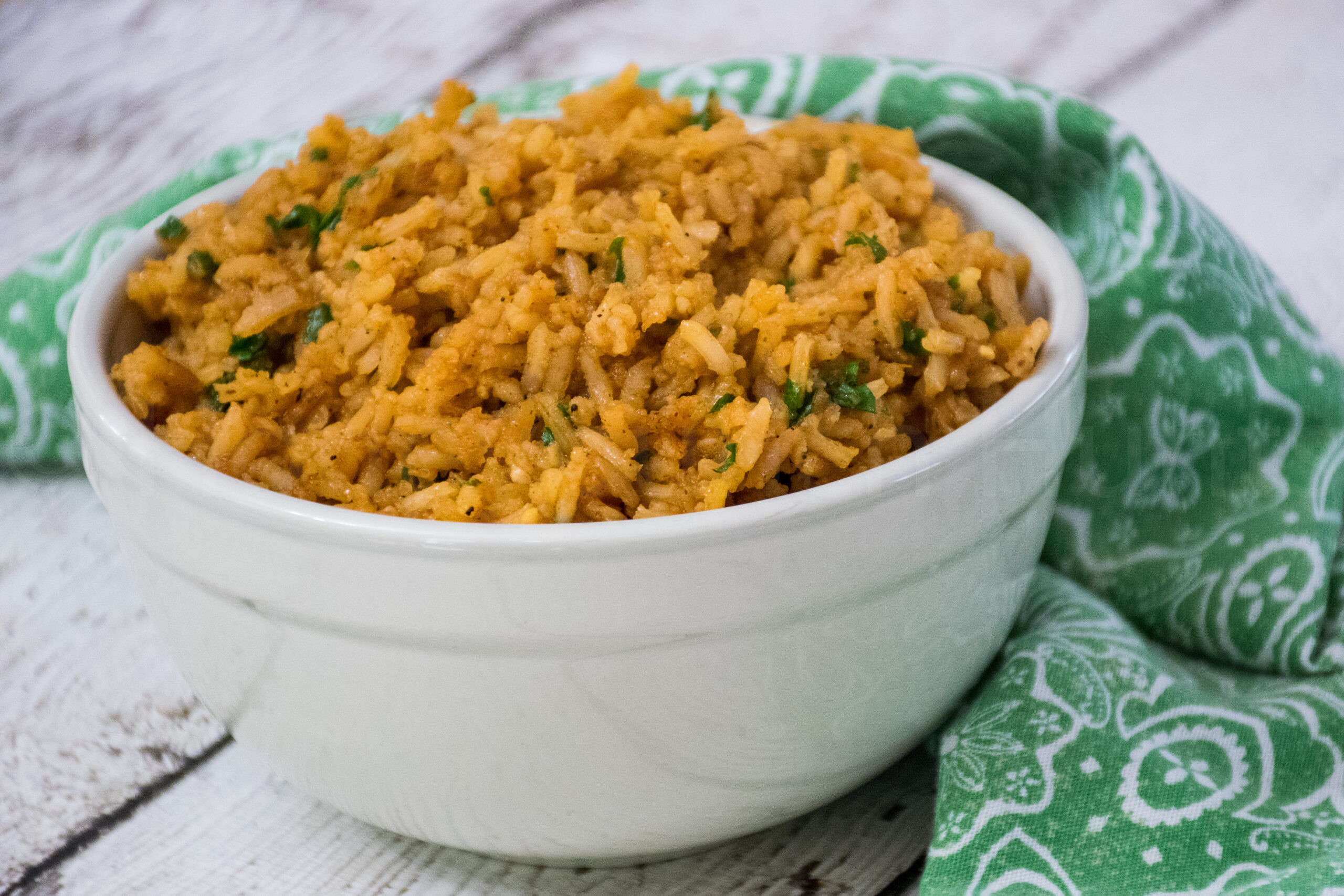 A white bowl filled with fluffy Spanish rice.