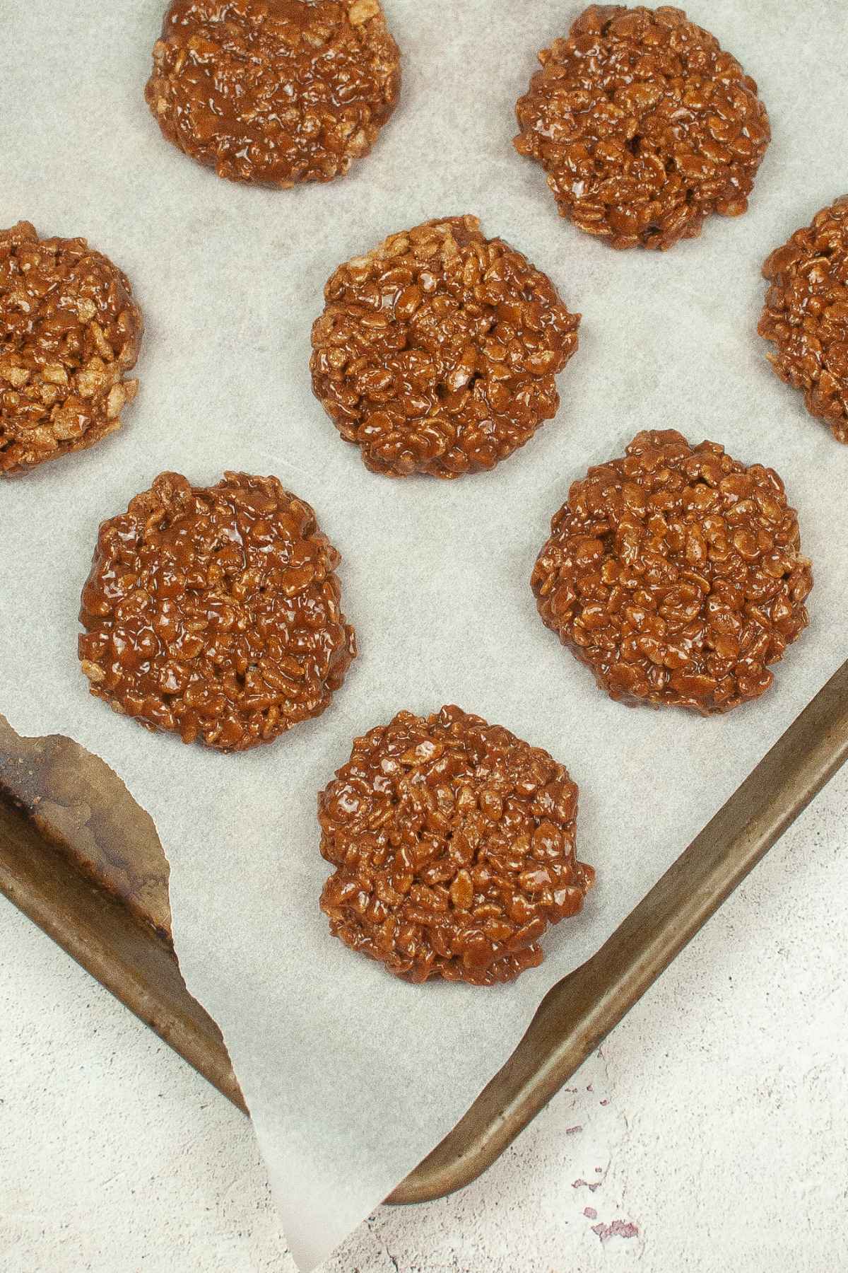 Freshly made Star Crunch cookies cooling on a parchment lined baking sheet.