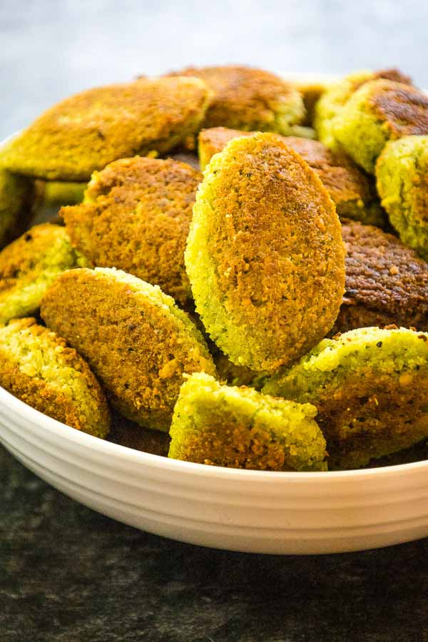 A white bowl filled with crispy, golden-brown homemade falafel patties.