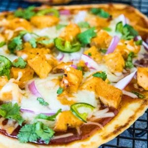 Crispy naan pizza topped with barbecue chicken, melted cheese, jalapenos and fresh cilantro.
