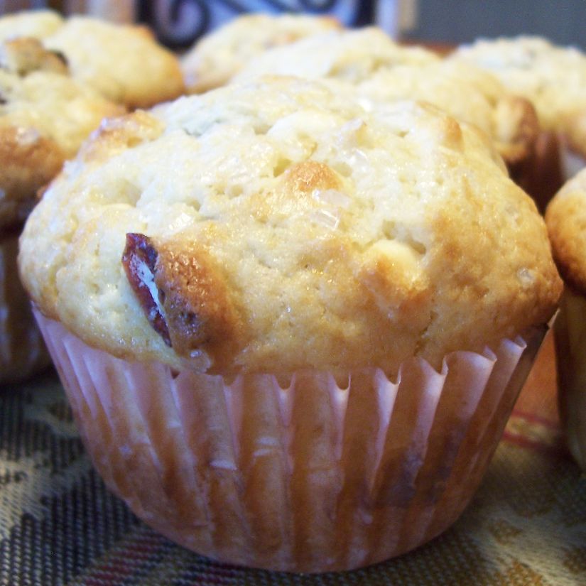 Golden brown muffins in paper liners cooling on a rack.