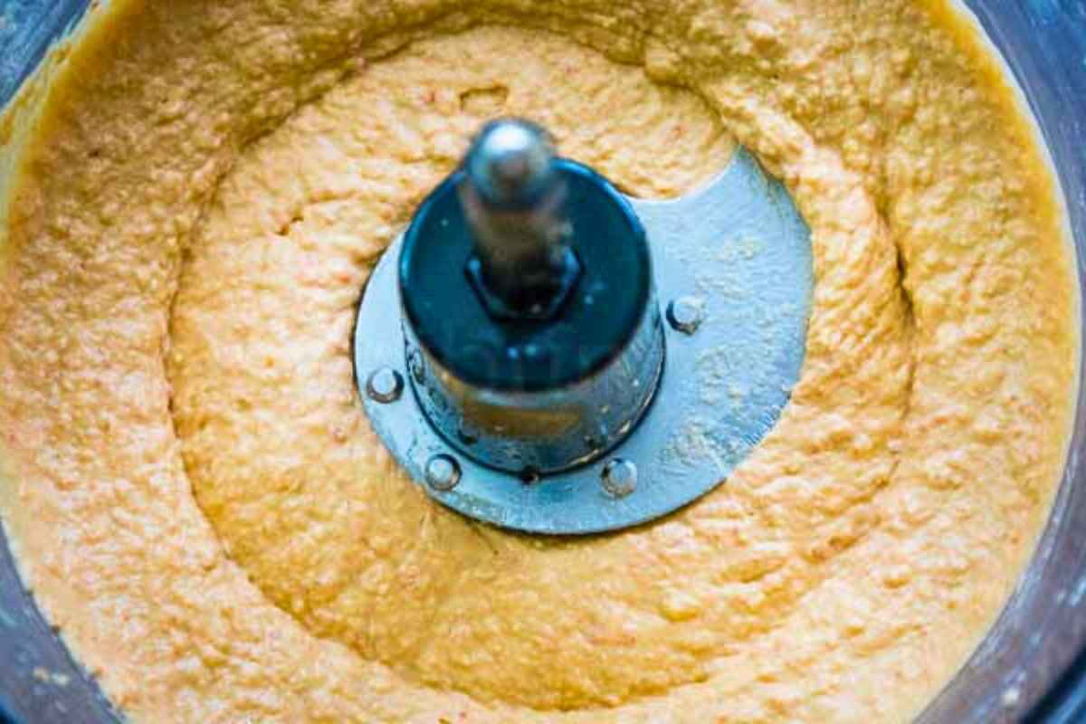 Smooth hummus blended in a food processor.