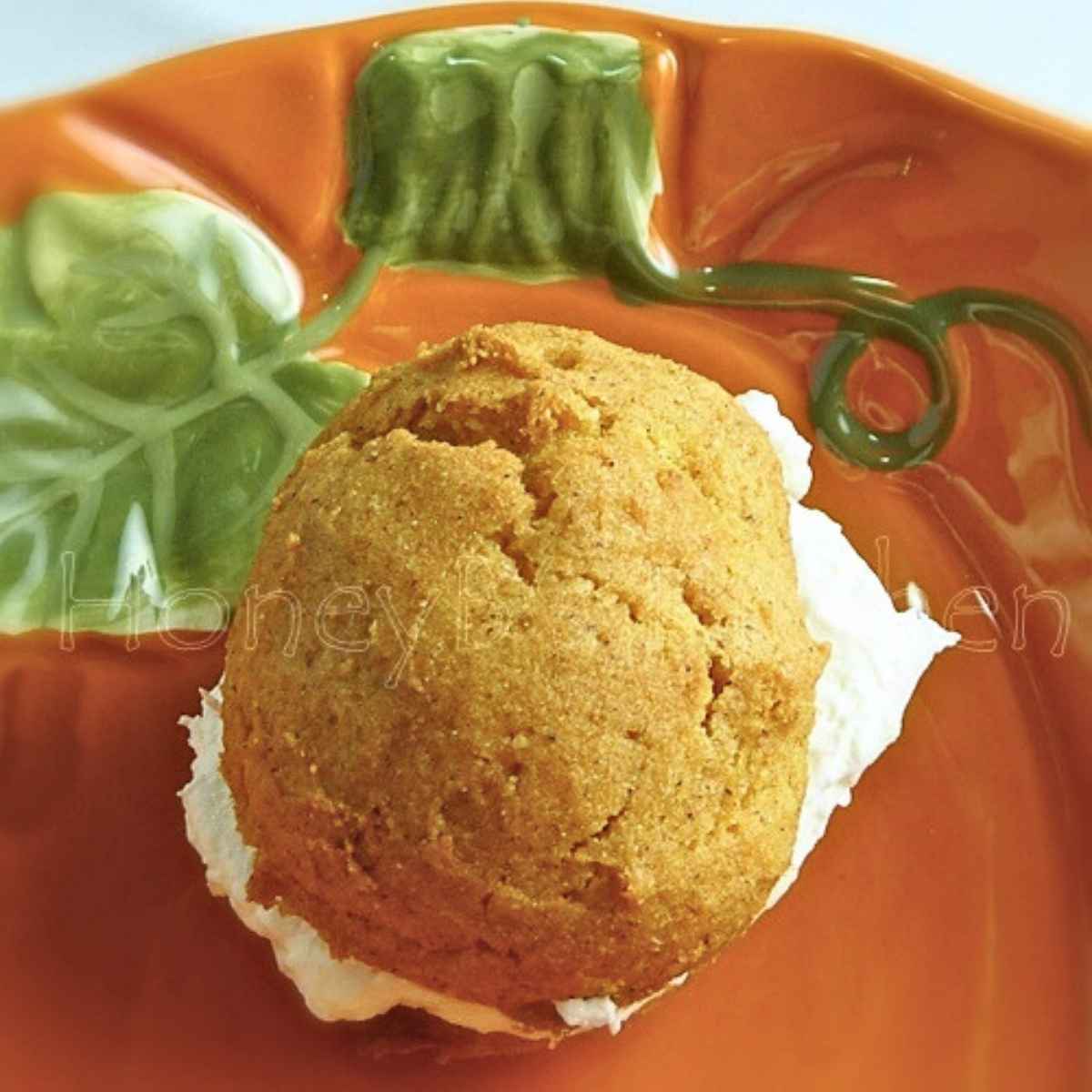 Soft pumpkin cookies with a marshmallow cream filling on a pumpkin platter.