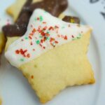 Lime Shortbread Cookie stars dipped in white chocolate coating and sprinkled with red and green sugar crystals.