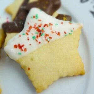 Lime Shortbread Cookie stars dipped in white chocolate coating and sprinkled with red and green sugar crystals.