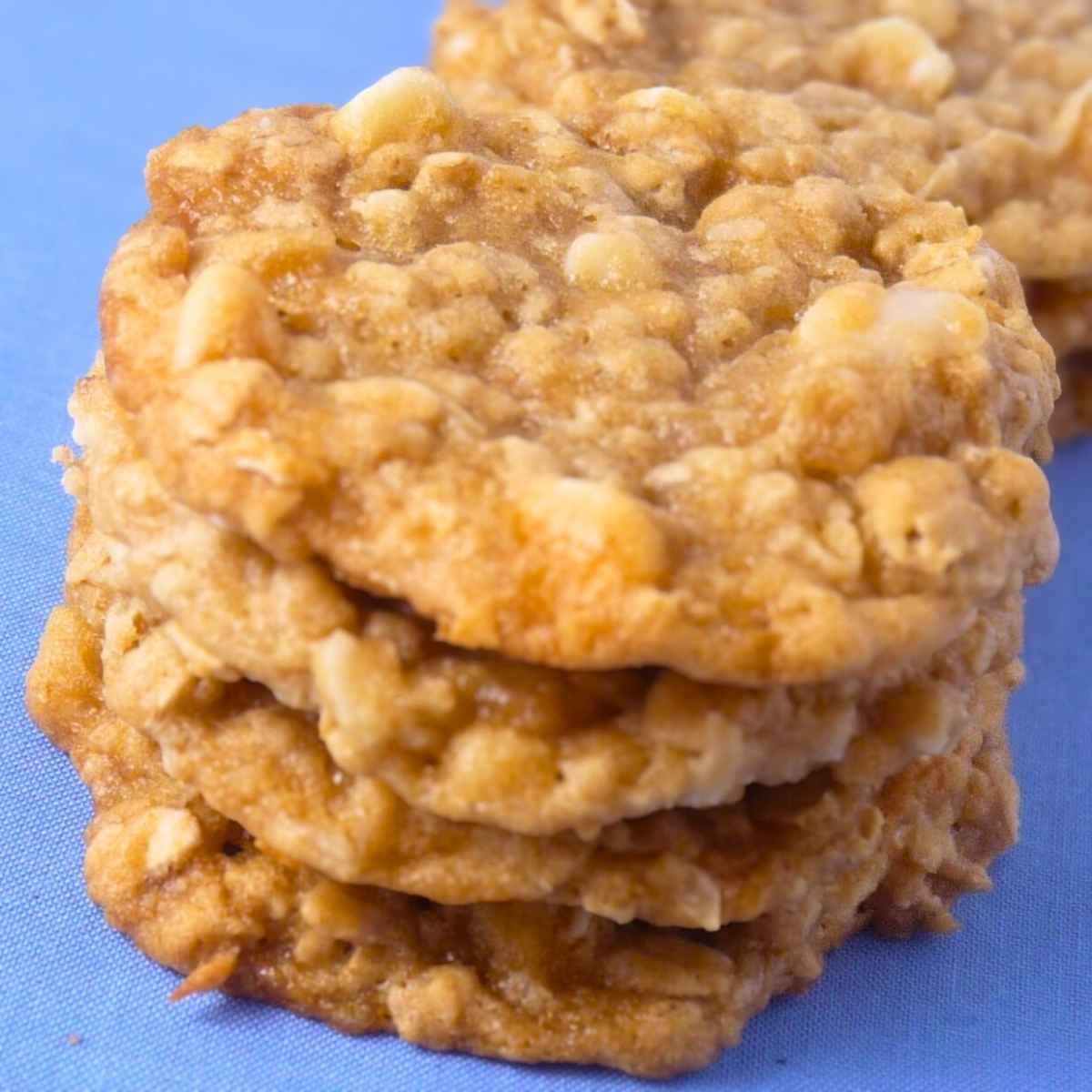 A stack of three honey oatmeal cookies studded with white chocolate chips.