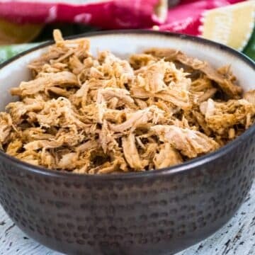 Instant Pot Pulled pork in a brown serving bowl.
