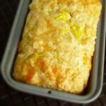 Overhead image of Beer cheese bread in the baking dish on a cooling rack.