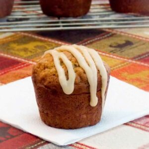 Close up of bakery style muffin topped with swirls of caramel icing.