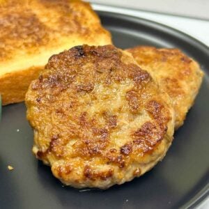 Homemade Chicken Breakfast Sausage patties golden-brown and crispy, served for breakfast with toast.