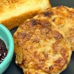 Homemade Chicken Breakfast Sausage patties golden-brown and crispy, served for breakfast with toast.