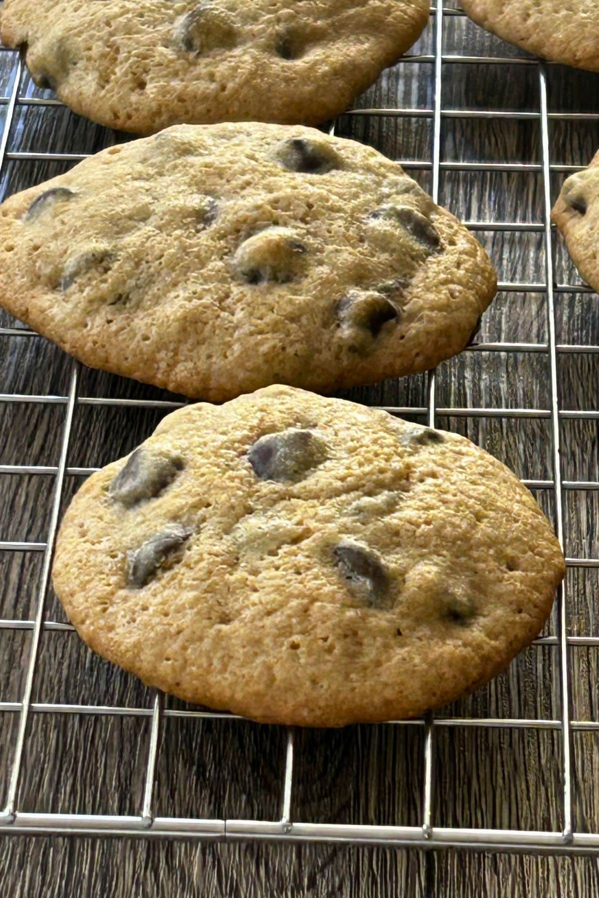 Golden brown soft chocolate chip cookies cooling on a wire rack.